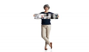 TAPS Reimagine direct mail held up by a middle aged woman
